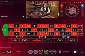 Das Foto zeigt ein Roulette Tisch und ein Video von dem dazugehörenden Live Dealer.