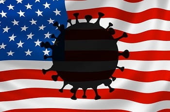 Auf einer US-Flagge prangt das Coronavirus.