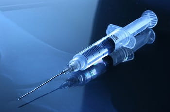 Eine mit Covid-19-Vaccine gefüllte Spritze.